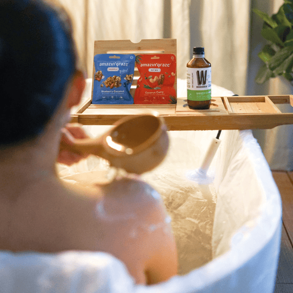 Person in a bathtub with Amazon Grasse products on a tray